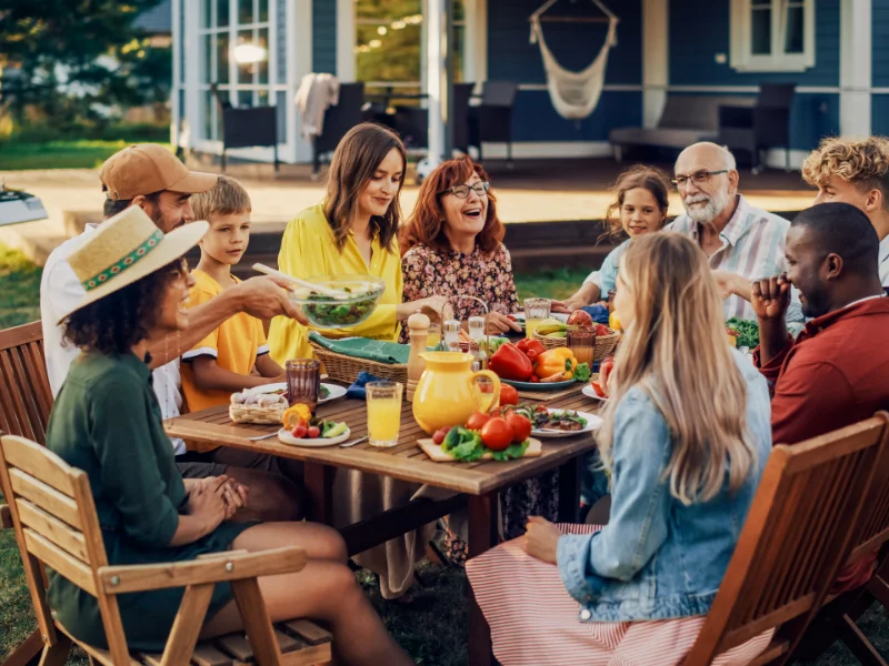 family sitting at outside picnic table